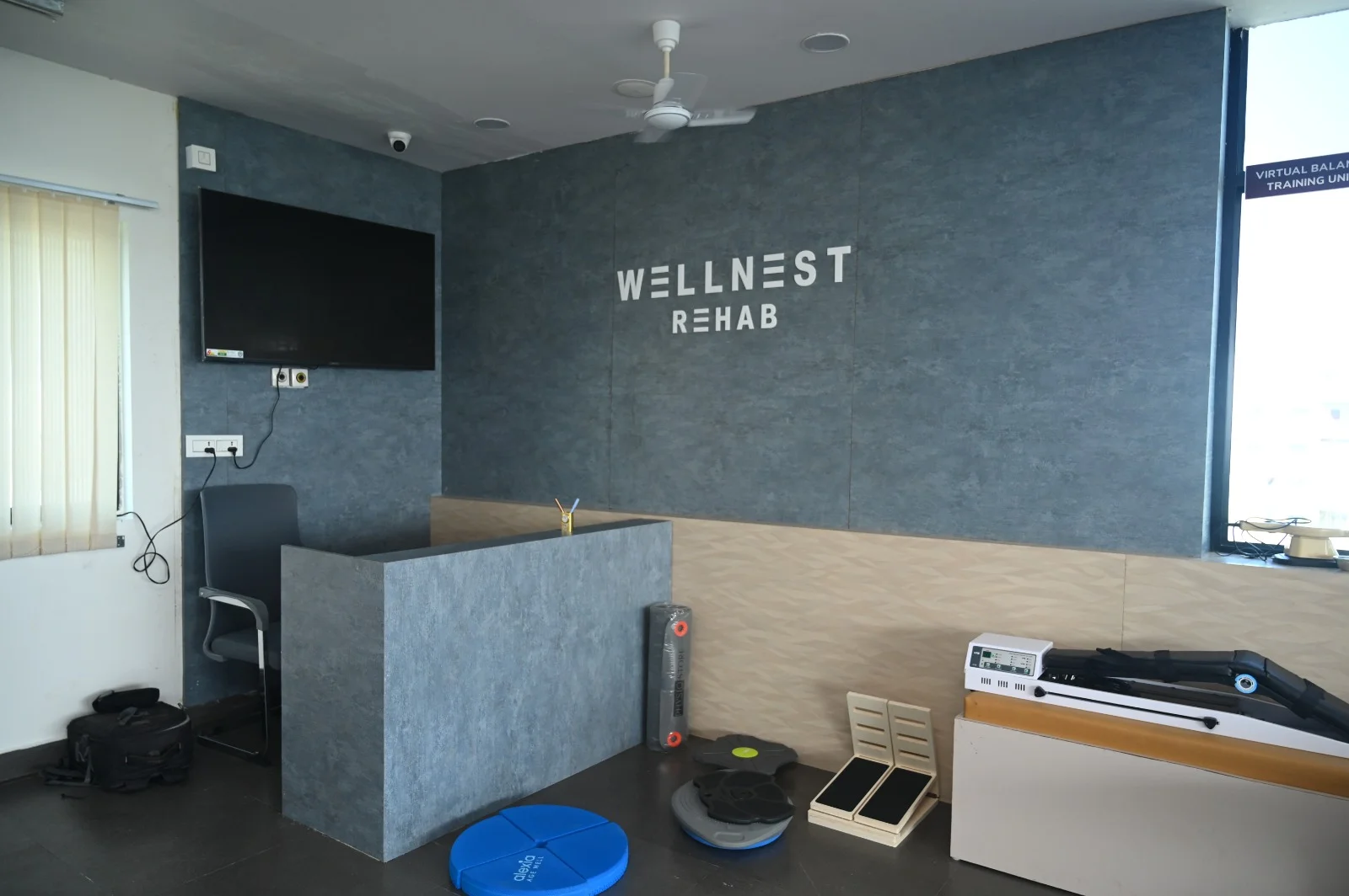 Wellnest reception area with seating and patient care information.